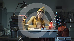 Smiling businesswoman working on Christmas Eve