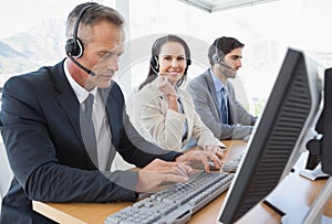 Smiling businesswoman working with teammates