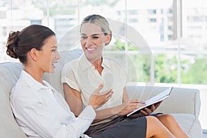 Smiling businesswomen talking and working together