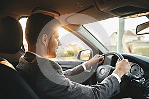 Smiling bussinesman driving car