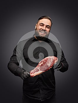 Smiling butcher with raw meat