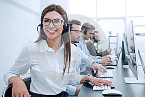 Smiling call center employee works in a modern office