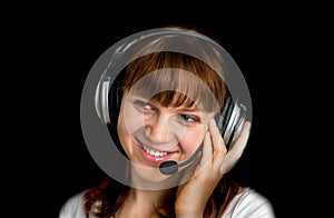 Smiling call centre operator with headset at workplace