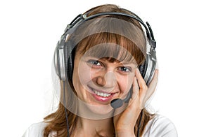 Smiling call centre operator with headset at workplace