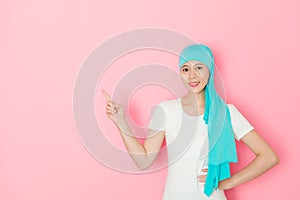 Smiling cancer patient standing in pink background