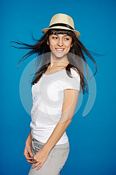 Smiling carefree woman wearing white straw hat