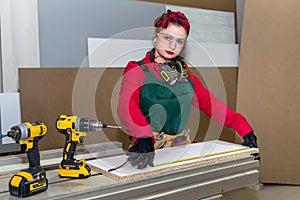 Smiling carpenter measuring wooden plank by meter