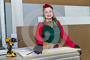 Smiling carpenter measuring wooden plank by meter