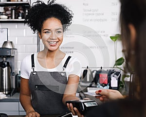 Smiling cashier accepting payment