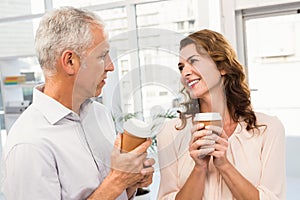 Smiling casual business colleagues having coffee together