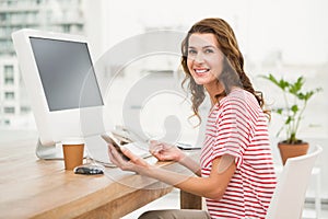 Smiling casual businesswoman using smartphone