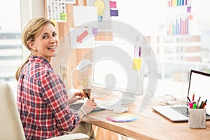 Smiling casual designer working with digitizer photo