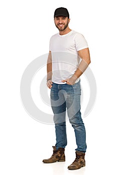 Smiling Casual Man Black Cap Is Standing With Hand In Pocket