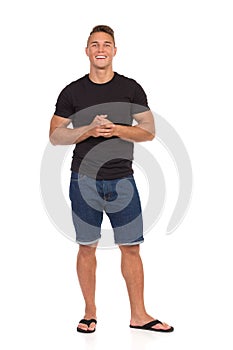 Smiling Casual Man In Jeans Shorts And Black Shirt