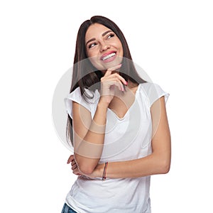 Smiling casual woman looking up to side while thinking