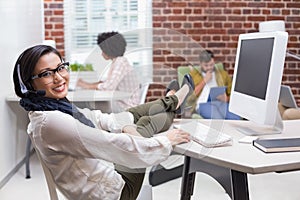 Smiling casual woman using computer