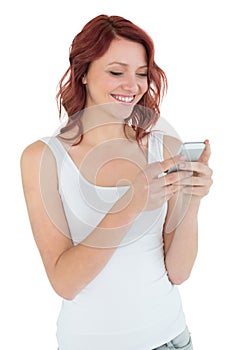 Smiling casual young woman text messaging