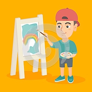 Caucasian boy artist painting picture on a canvas.