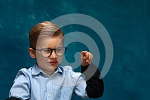 Smiling businessman child sitting at the table