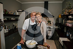 smiling caucasian elderly couple standing in kitchen