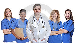 Smiling caucasian female doctor with 4 nurses
