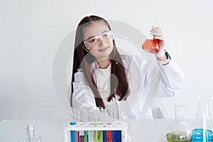 Smiling Caucasian girl student is study for research and test for chemical and science. She is experimenting at laboratory Lab of