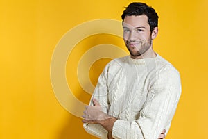 Smiling Caucasian Handsome Man In knitted Sweater Posing Against Yellow Background While Smiling Happily