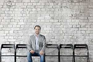 Smiling Caucasian male applicant wait for office interview