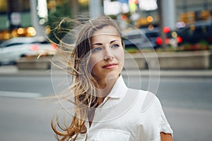 Smiling Caucasian woman girl with blue eyes with messy blond long hair on windy day outdoor, toned with Instagram filters