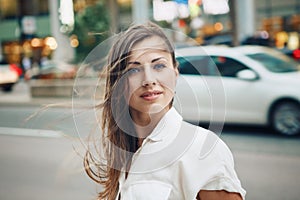 Smiling Caucasian woman girl with blue eyes with messy blond long hair on windy day outdoor, toned with Instagram filters