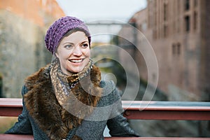 Smiling Caucasian woman looking away standing on a bridge