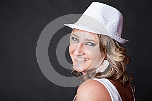 Smiling Caucasian woman wearing a pinstrip white hat photo