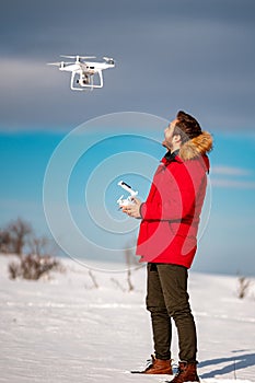 Smiling caucasian young adult flying hobby uav drone