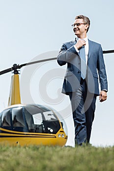 Smiling CEO taking a walk around helipad