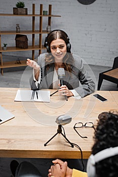 smiling and charming announcer in headphones