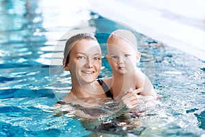 Smiling charming baby in swimming pool