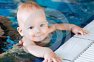 Smiling charming baby in swimming pool