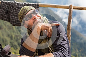 Smiling cheerful man guy tourist posing keffiyeh wearing sunglasses.