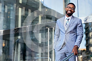 Smiling cheerful successful African American CEO businessman in stylish modern suit, happy warm distinguished portrait