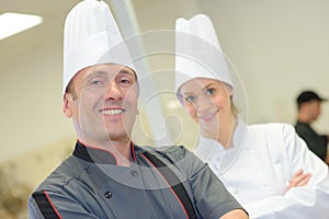 Smiling chef and commis chef