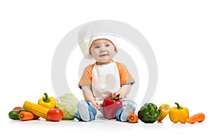 Smiling chef kid boy with vegetables isolated on white background