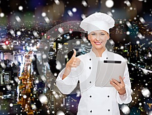 Smiling chef with tablet pc showing thumbs up