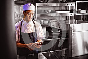 Chef using digital tablet in the commercial kitchen