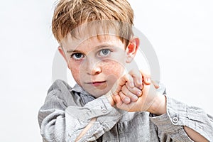 Smiling child with blue eyes looking determined, holding his fists