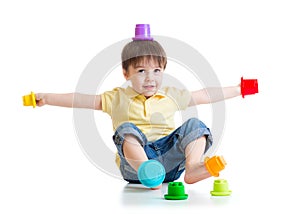 Smiling child boy having fun with color toys