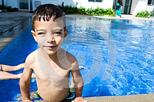 Smiling child boy at the swimming pool
