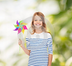 Smiling child with colorful windmill toy