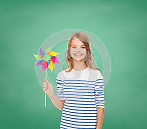 Smiling child with colorful windmill toy