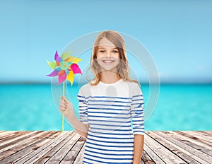 Smiling child with colorful windmill toy