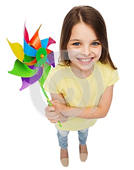 Smiling child with colorful windmill toy